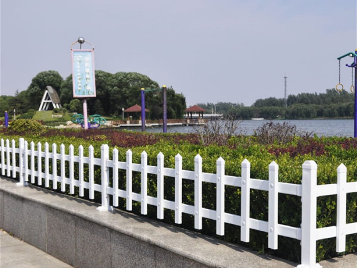 Planter railing running around a planted area beside a road