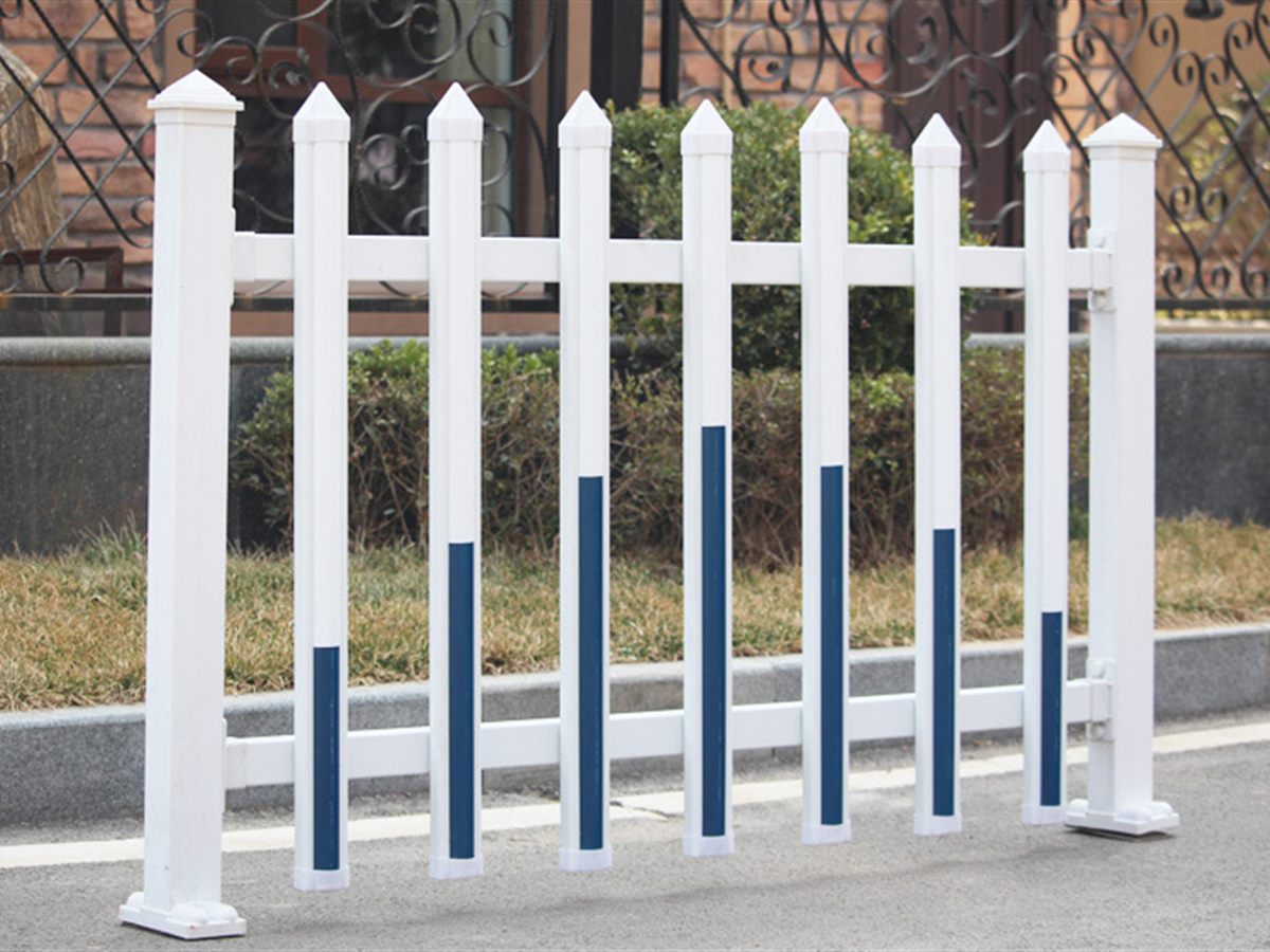 PVC Railing — PVC railing set along a lawn edge in a planted area