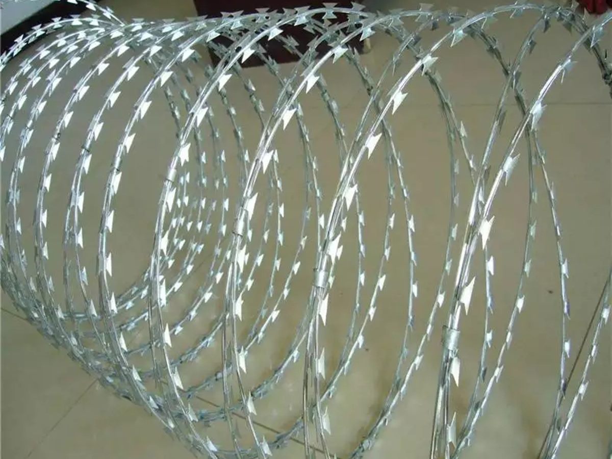 Razor wire and barbed wire coils stacked ready for packing and shipping (thumbnail 3)